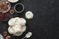 Cooking dessert. Abstract food background. Top view of mini Pavlova meringue cakes decorated with berries and figs