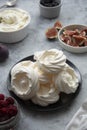 Cooking dessert. Abstract food background. Top view of mini Pavlova meringue cakes decorated with berries and figs