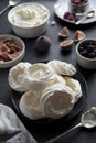 Cooking dessert. Abstract food background. Top view of mini Pavlova meringue cakes decorated with berries and figs