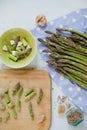 Cooking dinner. Fresh raw asparagus, garlic and smoked salt in a vintage bottle