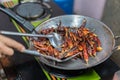 Cooking dried red chilies in pan