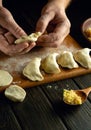 Cooking dumplings by hand on the kitchen table. Chef preparing breakfast in saloon kitchen Royalty Free Stock Photo