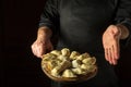 Cooking dumplings in the kitchen of the restaurant by the hands of the chef. Presentation of dumplings on a cutting board. Royalty Free Stock Photo