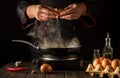 Cooking an egg dish or an omelet. A novice chef is practicing in the kitchen of a restaurant Royalty Free Stock Photo