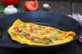 Cooking egg omlette with ham and mushrooms