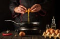 Cooking an eggs dish or an omelet in the kitchen. The chef pours a raw egg into a frying pan. Delicious breakfast menu idea for a Royalty Free Stock Photo