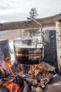 Cooking in field conditions, boiling pot at the campfire on picnic