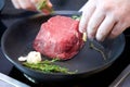 Cooking fillet of beef steak cooking in a frying pan. Royalty Free Stock Photo