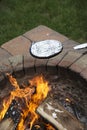 Cooking a foil covered pan of popcorn on fire pit