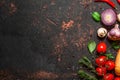 Cooking food background. Fresh vegetables, mushrooms, spices and herbs on black stone table. Top view Royalty Free Stock Photo