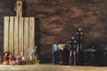 Cooking food background: rustic wood kitchen table, cast iron pan, spice grinders, cutting board, spices and seasonings, storage Royalty Free Stock Photo