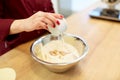 Chef with flour in bowl making batter or dough