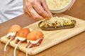 Cooking, food close up of male hands grating cheese sprinkled on the stuffed eggplant Royalty Free Stock Photo