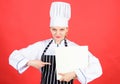 Cooking food and culinary as hobby. Cook looking for cooking recipe in cookbook. Woman reading cook book in kitchen