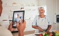 Cooking food, elderly couple and tablet photo of senior woman, wife or person with digital memory picture. Vegetables