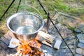 Cooking food on fire. Cooking outdoors in cast-iron cauldron. Royalty Free Stock Photo