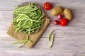 Green beans and vegetables on a wooden background Royalty Free Stock Photo