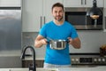 Cooking food at home. Man in kitchen preparing a meal. Male cook preparing food in kitchen at home. Chef cooking meal Royalty Free Stock Photo