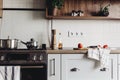 Cooking food on modern kitchen with steel oven, pots, knife on wooden cutting board with vegetables, pepper, spices,oil on wooden Royalty Free Stock Photo