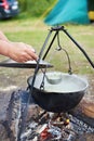 Cooking food over campfire in hike Royalty Free Stock Photo