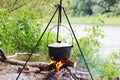 Cooking food in summer at stake in cauldron