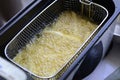 Cooking french fries in a fryer Royalty Free Stock Photo