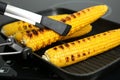 Cooking fresh corn cobs on grill pan Royalty Free Stock Photo