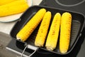 Cooking fresh corn cobs on grill pan Royalty Free Stock Photo