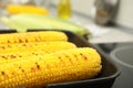 Cooking fresh corn cobs on grill pan, closeup Royalty Free Stock Photo