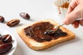 Cooking fresh crispy toast with dates jam on white table.