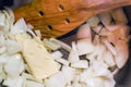 Cooking freshly chopped onion with butter to saute in a saucepan