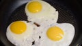 Cooking fried eggs in a pan. Three egg whites and yolks. Omelet for breakfast. Royalty Free Stock Photo