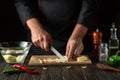 Before cooking fries in the kitchen, the cook cuts the potatoes into small pieces. Hands of a chef with a knife. Vegetable diet Royalty Free Stock Photo