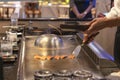 Cooking and frying fish in a Japanese Tepanyaki pan. show for visitors of a Japanese restaurant, traditional national Royalty Free Stock Photo