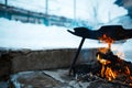 Cooking in frying pan on open fire, winter day Royalty Free Stock Photo