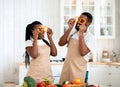 Cooking Fun. Cheerful African American Spouses In Aprons Fooling In Kitchen Royalty Free Stock Photo