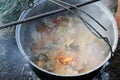 Cooking goulash in a kettle on the open fire