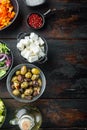 Cooking Greek salad, on old dark  wooden table background, top view flat lay  with copy space for text Royalty Free Stock Photo