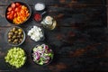 Cooking Greek salad, on old dark  wooden table background, top view flat lay  with copy space for text Royalty Free Stock Photo