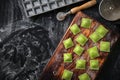 Fresh green ravioli on a wooden Board