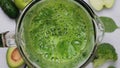 Cooking green smoothie in blender. Green vegetables, fruits and leaves blended in blender. Slow motion. Healthy detox
