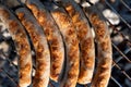 Cooking Grilled juicy sausages at bbq grill backyard Grilling on charcoal. Sausages on the grill Royalty Free Stock Photo