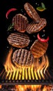 Cooking Hamburger cutlet. Conceptual picture. Steak with spices and cutlery under burning grill grate Royalty Free Stock Photo