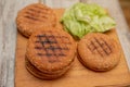 Cooking hamburgers, making a hamburger, pictures with buns, vegetables on the table. rolls. Iceberg lettuce leaves Royalty Free Stock Photo