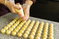 Cooking handmade chocolates. A confectioner pours liquid white chocolate into molds. Close-up. Selective focus. Royalty Free Stock Photo