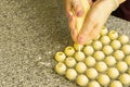 Cooking handmade chocolates. A confectioner pours liquid white chocolate into molds. Close-up. Selective focus. Royalty Free Stock Photo