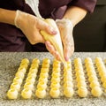 Cooking handmade chocolates. A confectioner pours liquid white chocolate into molds. Close-up. Selective focus. Royalty Free Stock Photo
