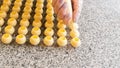 Cooking handmade chocolates. A confectioner pours liquid white chocolate into molds. Close-up. Selective focus. Royalty Free Stock Photo