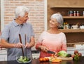 Cooking, health and help with old couple in kitchen for salad, love and nutrition. Happy, smile and retirement with Royalty Free Stock Photo