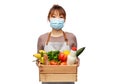 female chef in mask with food in wooden box Royalty Free Stock Photo